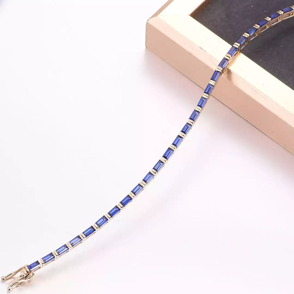 14K yellow gold bracelet set with baguette-cut lab-grown blue sapphires in a continuous line setting