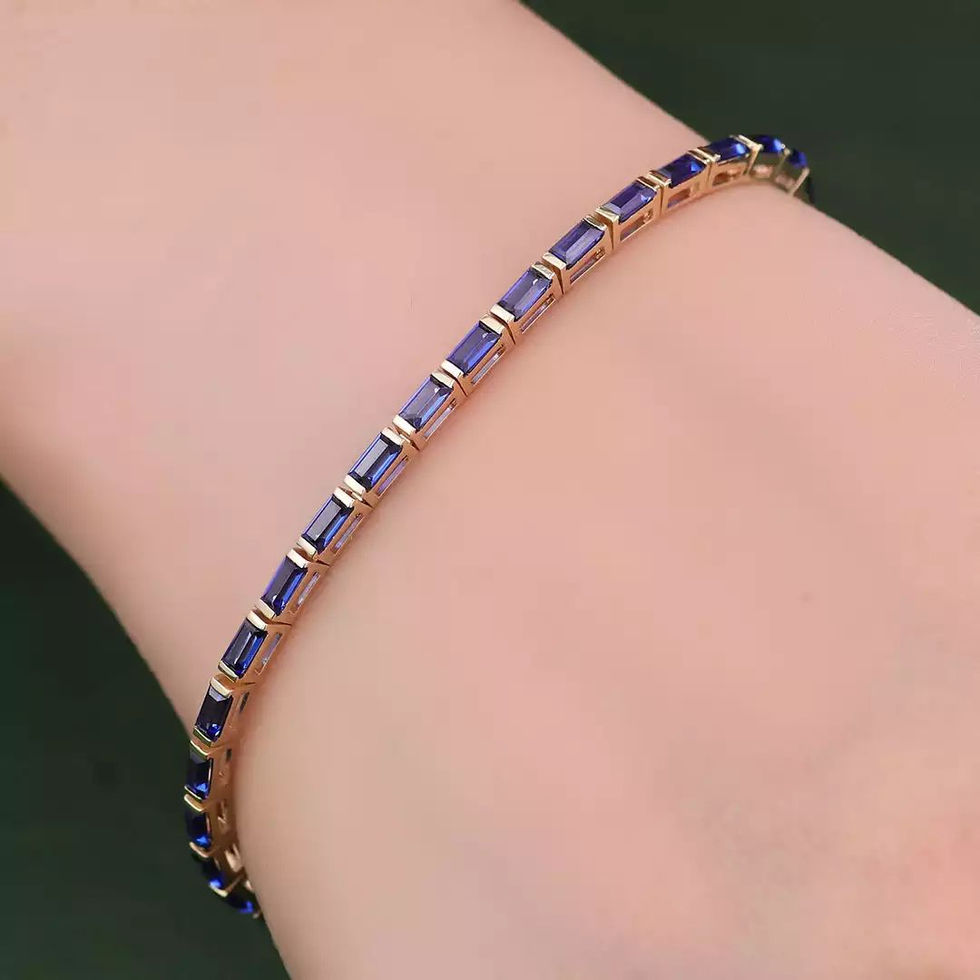 Baguette-cut lab sapphire bracelet in 14K gold worn on the wrist