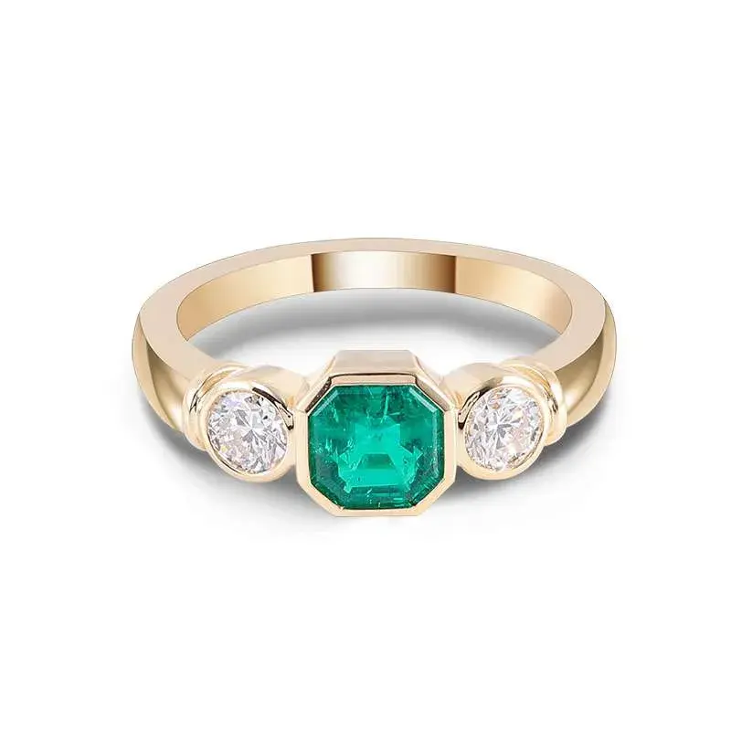 Elegant three-stone ring featuring a lab-grown Colombian emerald in Asscher cut, accented by brilliant diamonds. Available in