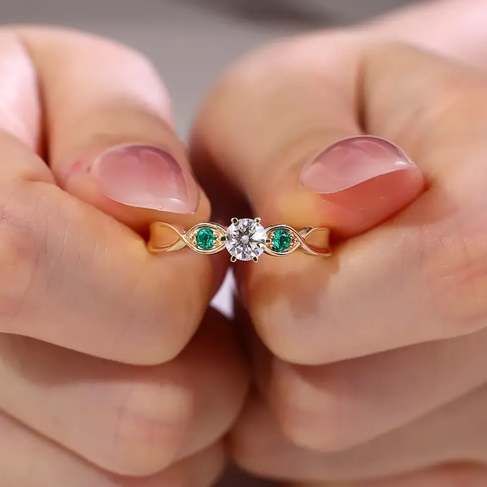 Close-up of round diamond three-stone ring on slim gold band