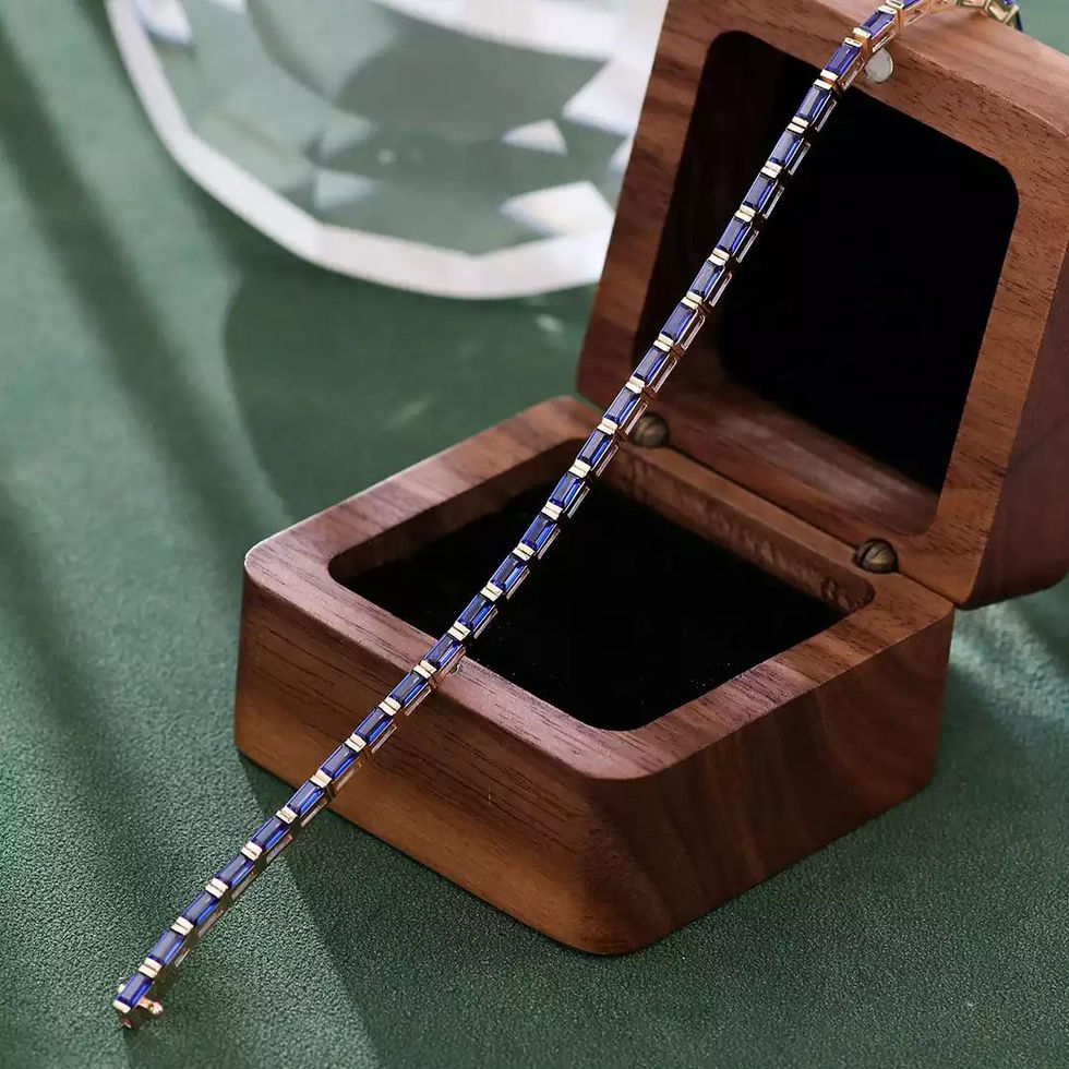 14K yellow gold bracelet set with baguette-cut lab-grown blue sapphires in a continuous line setting