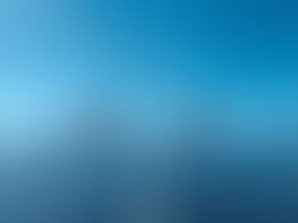 Commercial solar installers cleaning and installing solar panels on a large rooftop under clear blue skies.