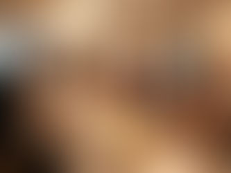 Luxurious indoor wedding reception with elegant chandeliers, uniformed catering staff serving guests, a smiling bride at a candlelit banquet table, and a tiered white wedding cake with floral decorations