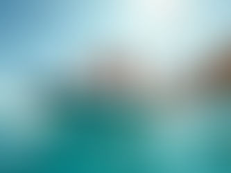 A cruising family enjoys a day on the water aboard a Highfield Classic 310 RIB tender near their sailboat under clear blue skies