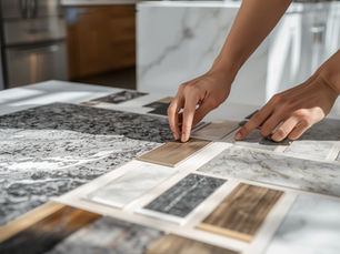 Homeowner comparing kitchen and bathroom countertop samples in a showroom, evaluating material textures and colors