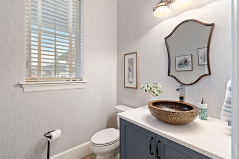 French Elegance powder room with a decorative mirror and vessel basin.