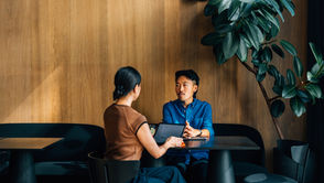 Two discussing at a table
