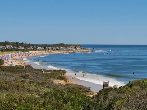 Surf and relax at Ditch Plains Beach in Montauk NY with scenic cliffs, waves, and Hamptons charm.