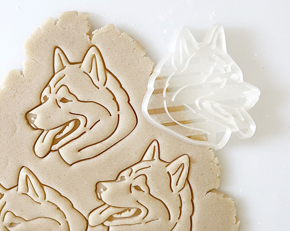 Thumbnail: Malamute cookie shapes stamped into cookie dough