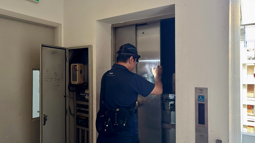 BELIFT technician with headlamp inspects an elevator shaft control panel in a bright utility hallway, with fire warning and wheelchair signs.