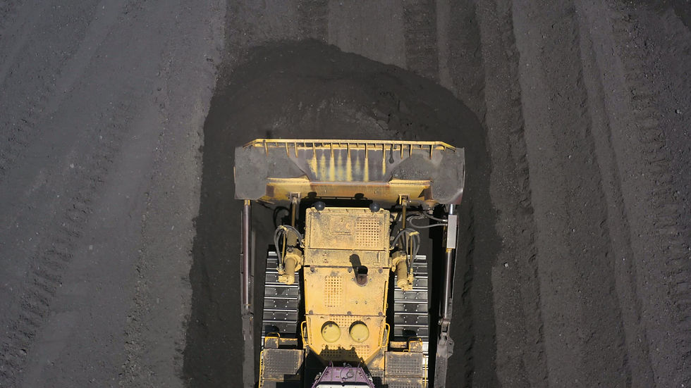 Aerial view of bulldozers directing coal at a thermal power plant for efficient energy pro