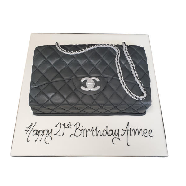 Luxurious designer handbag-shaped cake decorated with intricate details, perfect for fashion lovers and special occasions.