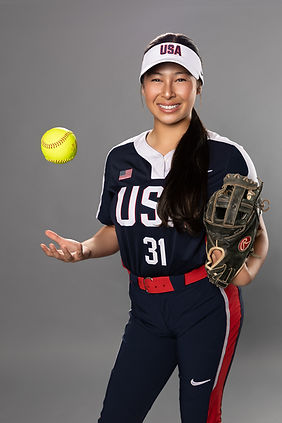 Action-style studio image of a teen softball player posed with glove and game-day energy—p