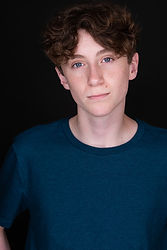 Studio headshot of a male actor with confident eye contact and subtle smile—ideal for casting submissions, IMDB profiles, and talent agency portfolios.