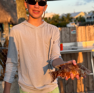 Will with an exotic canal fish from the dock