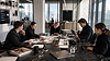A multidisciplinary social media marketing team planning content strategies, reviewing campaign performance, coordinating photography and videography production, and managing digital marketing initiatives within a premium modern workspace.