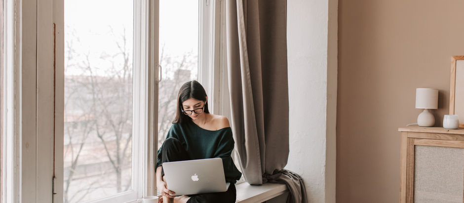 A woman sitting next to her winter with her laptop