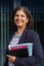 Smita Salagare holding a tablet and documents