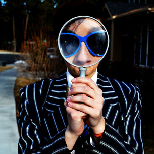 A man with glasses and a magnifying glass