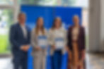 A group of people posing for a photograph holding certificates.
