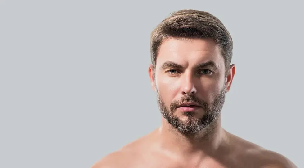 A shirtless man with a beard, showcasing a rugged and masculine appearance, embodying the essence of men's beards.