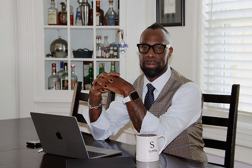 Stephen seated with bar background