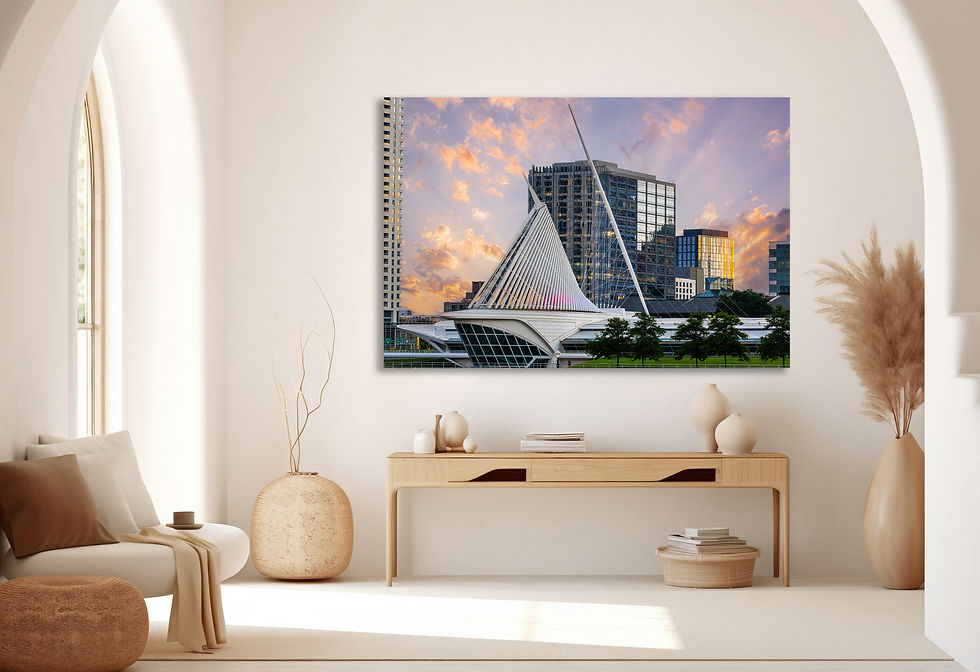 Architectural photograph of the Milwaukee Art Museum at sunset, showcasing its sail-like structure with surrounding skyscrape