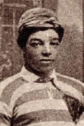 Black and White image of Scottish Black footballer Andrew Watson. Grainy picture. Male wearing a horrible looking pinstripe suit.