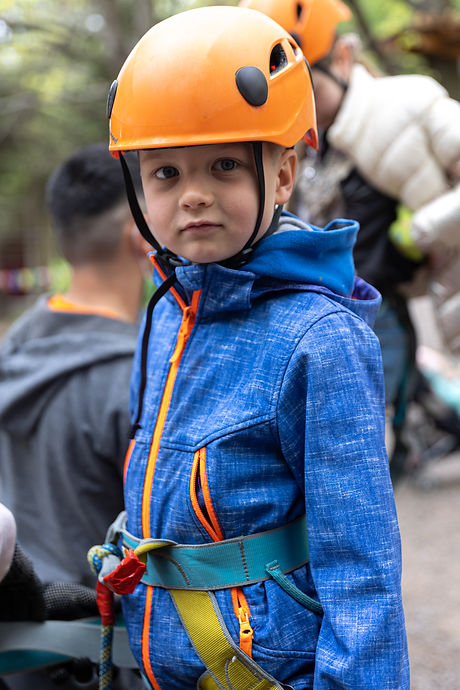 adventure-climbing-high-wire-park-little-boy-on-course-in-mountain-helmet-and-safety-equip