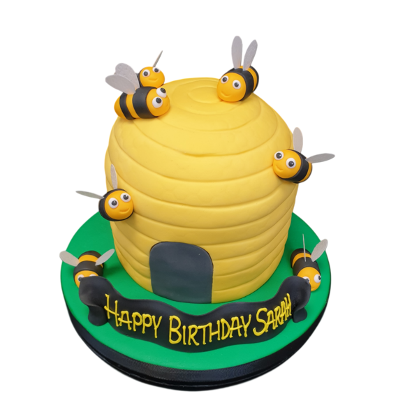 Beautifully decorated beehive cake with intricate fondant detailing, perfect for celebrating special occasions or enjoying with loved ones.