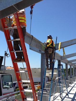 Local minority union ironworkers erecting steel canopy on newly built MBTA station in Roxbury MA.