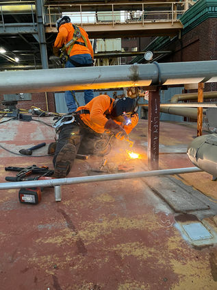 Certified welders working Industrial storage tank repairs and upgrades for a local utility facility in Quincy-Weymouth Massachusetts