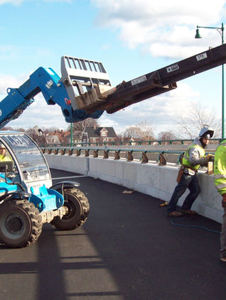 Minority union ironworkers installing protectivr guard rail on Boston-Quincy bridge in Massachusetts