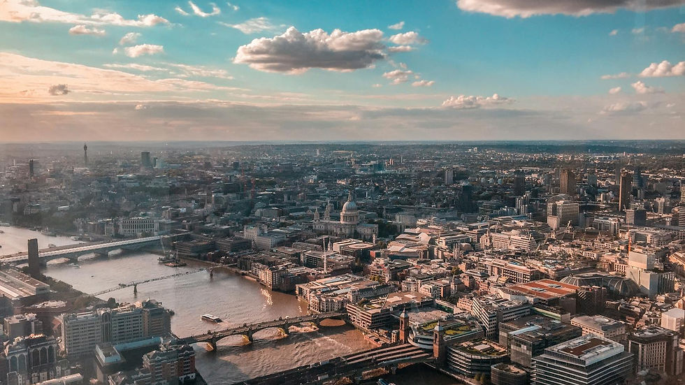 Breathtaking aerial view of London's skyline featuring iconic landmarks and River Thames, capture during sunset.