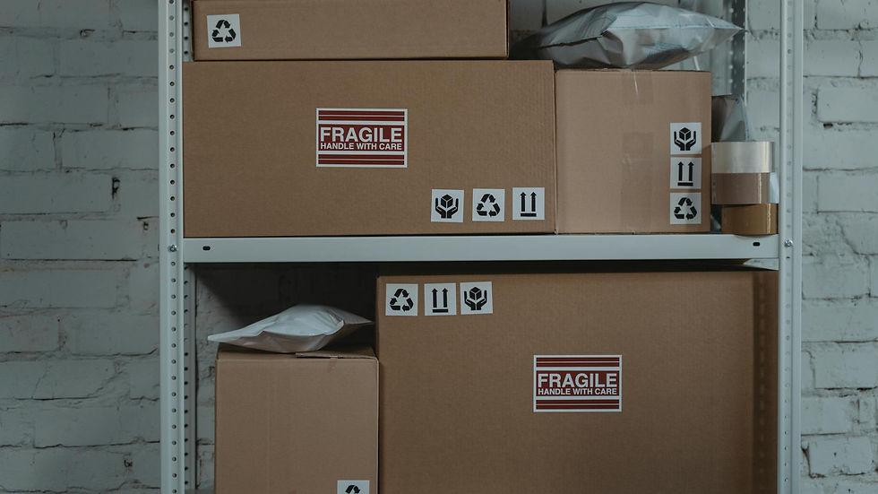 Cardboard boxes labeled 'Fragile' stacked on metal shelving in a storage room.