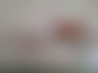 Babykamerdecoratie met een naam "NORAH" in vilten letters, omringd door knuffels, een kinderboek en een vlinder op een plank met bloemenbehang op de achtergrond.