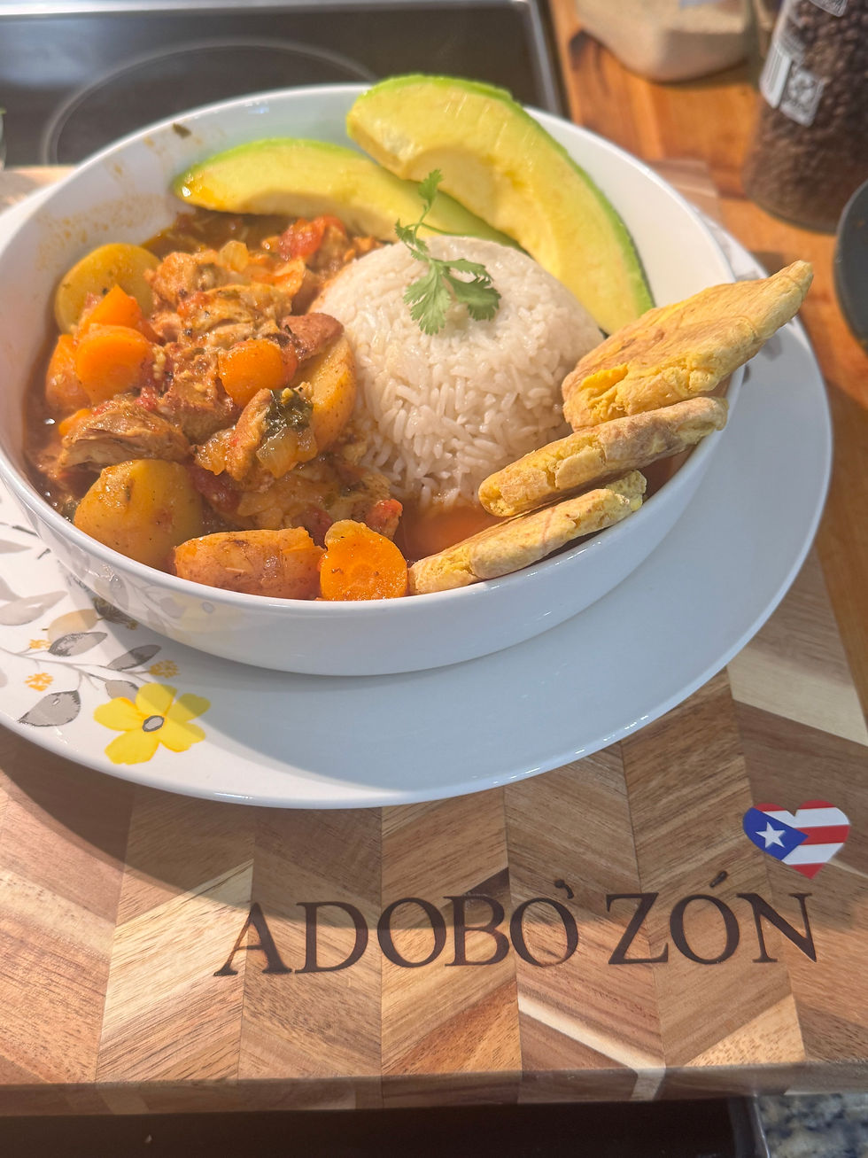 Pollo Guisado made with Adobo'Zon, serve with rice, avocado and tostones