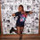 Thumbnail: owner Kirsty wearing their t-shirt. making a heart with her hands