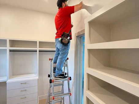 SecuriMax technician on a ladder carrying out indoor installation work