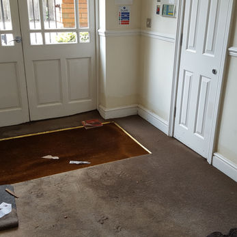Flood damage to entrance hall in block of flats