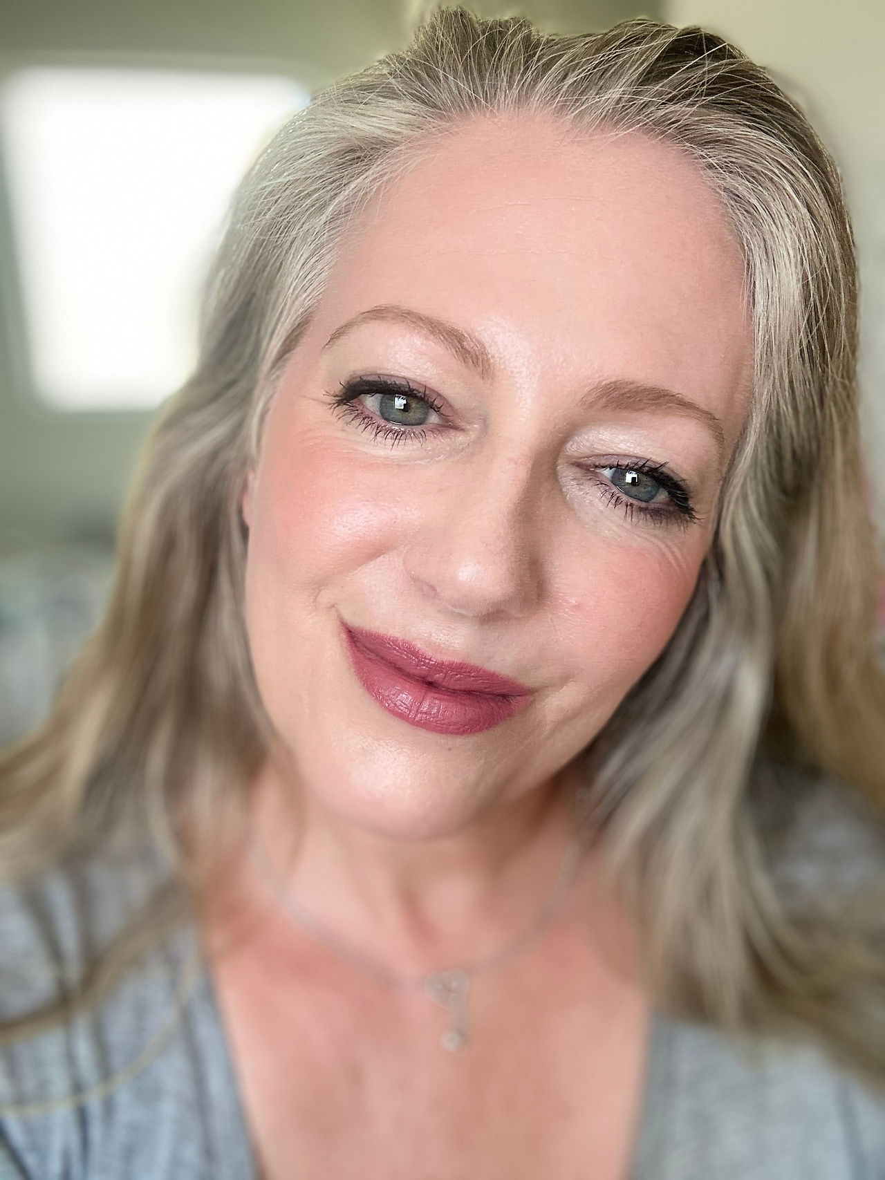 Author wearing rosebud and smiling