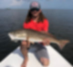 Man holding up a Florida Redfish he caught in Crystal River.