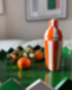 Orange and off-white hand-painted striped cocktail shaker with glossy finish.
