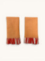 Pastel cotton ruffle napkins with contrasting striped trim, styled on a dining table - Peach and Tangerine Stripe
