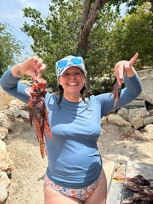 Lynette Brown holding up her lionfish catch