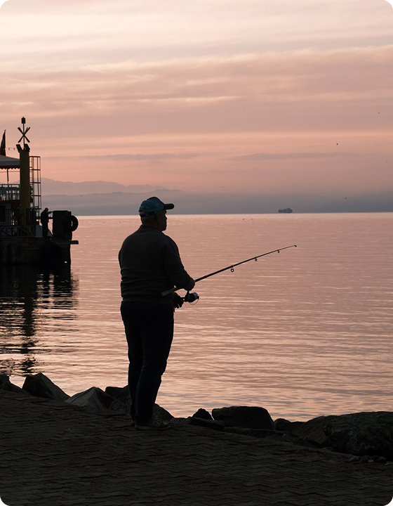 An angler holding a finished Trident custom rod