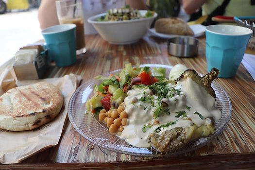 Roasted aubergine with chickpeas, tahini, salad and pitta bread
