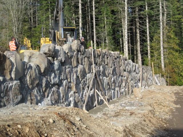 Engineered retaining wall in the process of being built in Royal Bay Colwood BC built by Victoria Landscaping Ltd