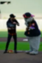 San Francisco Magician Spencer Grey opens a smoking wooden chest on the pitcher's mound with Giants mascot Lou Seal
