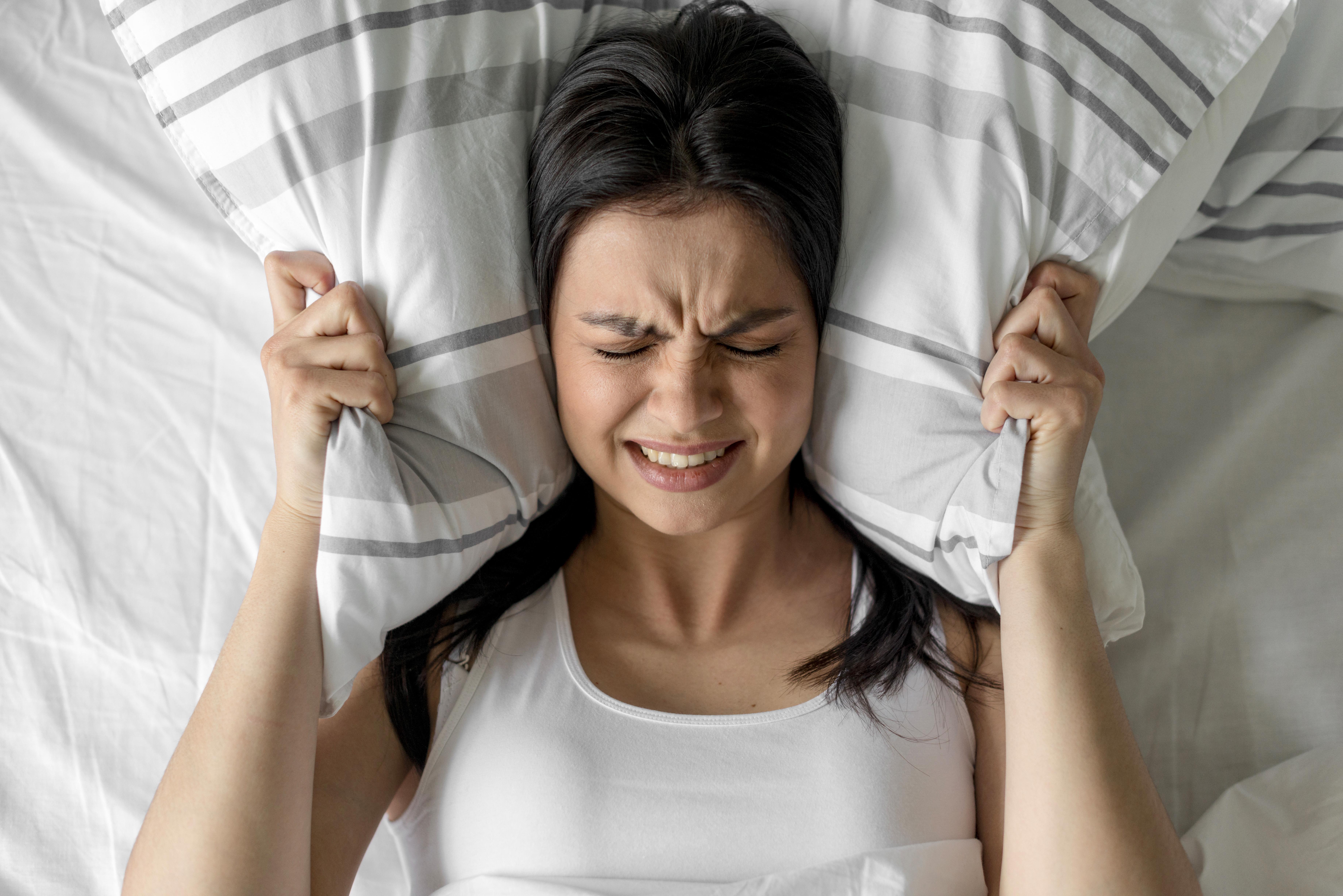 top-view-young-woman-holding-pillow-bed.jpg